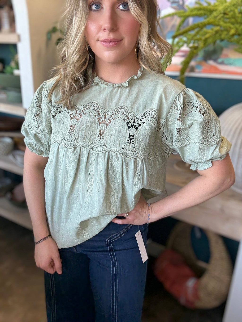 woman wearing sage green lace puff sleeve boutique blouse with embroidered fabric

Tags