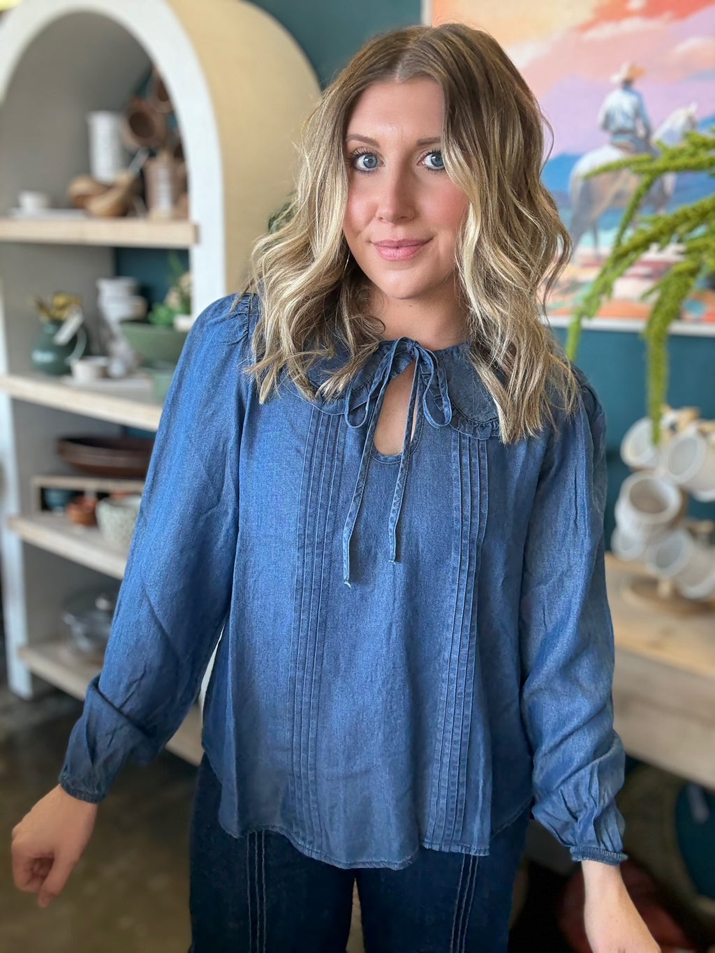 woman wearing chambray boutique blouse with tie neckline and pintuck detailing