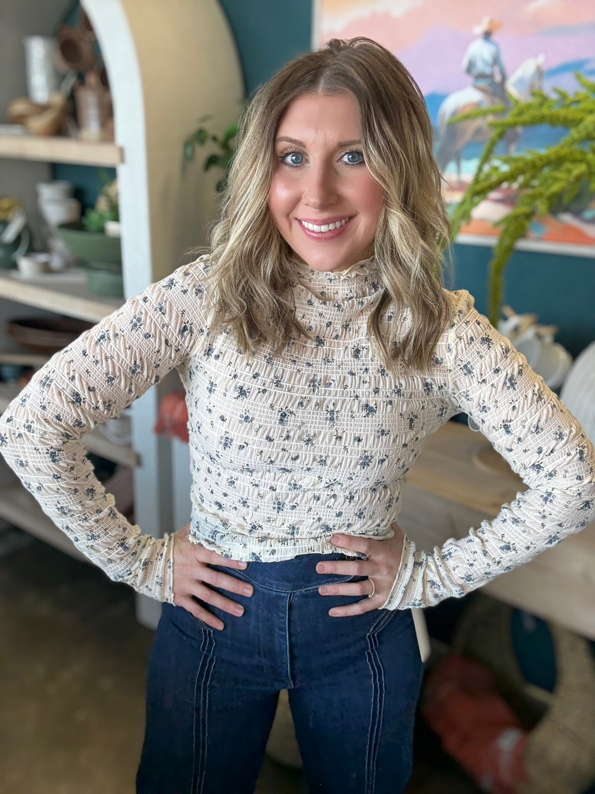 woman wearing floral smocked mock neck boutique top with long sleeves