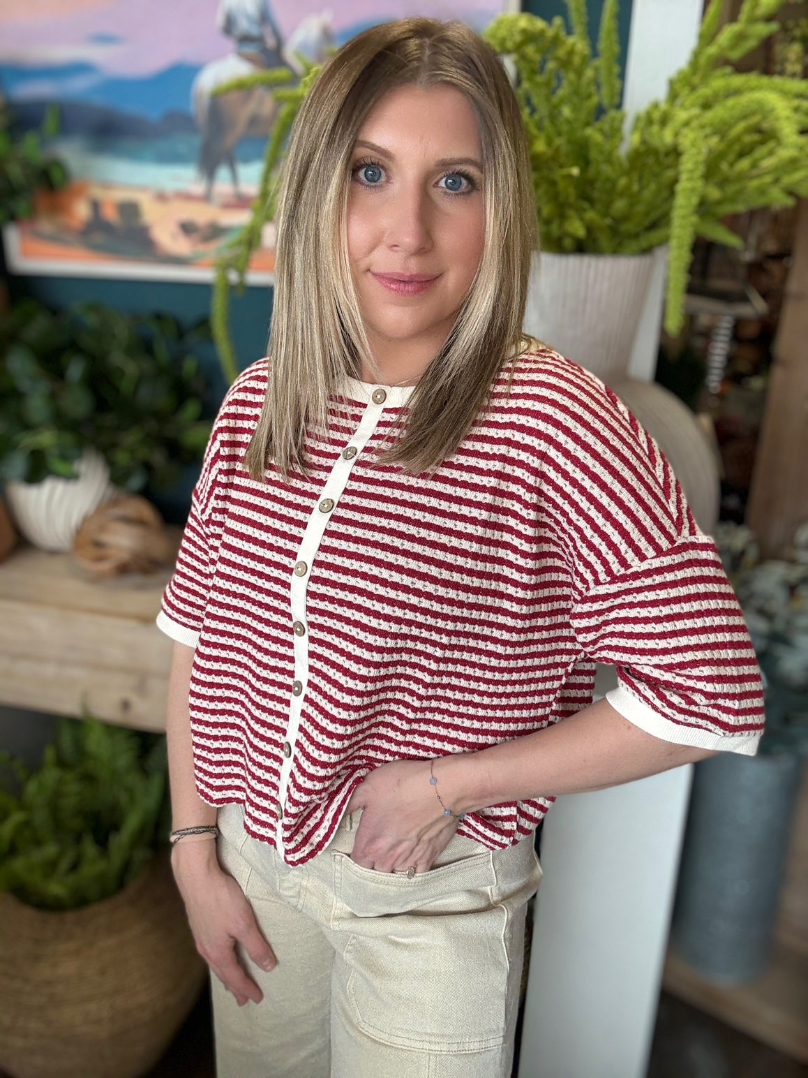 Red and cream striped button front boutique top styled with neutral pants at Pill Box Boutique
