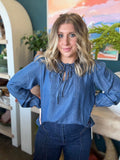 woman wearing chambray boutique blouse with tie neckline and pintuck detailing