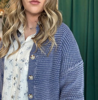 Woman wearing a denim-blue and ivory marled knit button-front cardigan with oversized buttons and dropped shoulders.