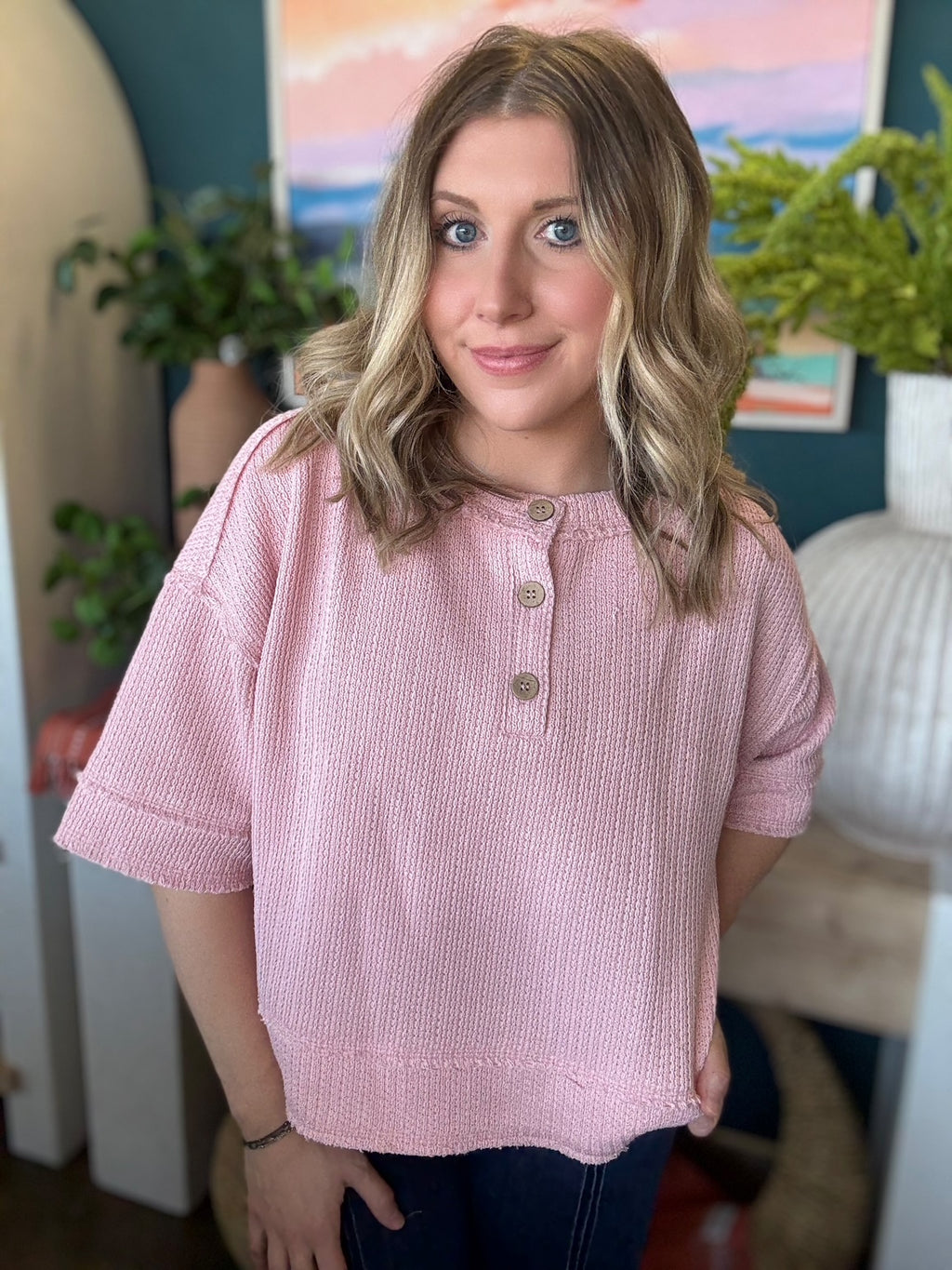 woman wearing blush pink waffle knit boutique top with button neckline