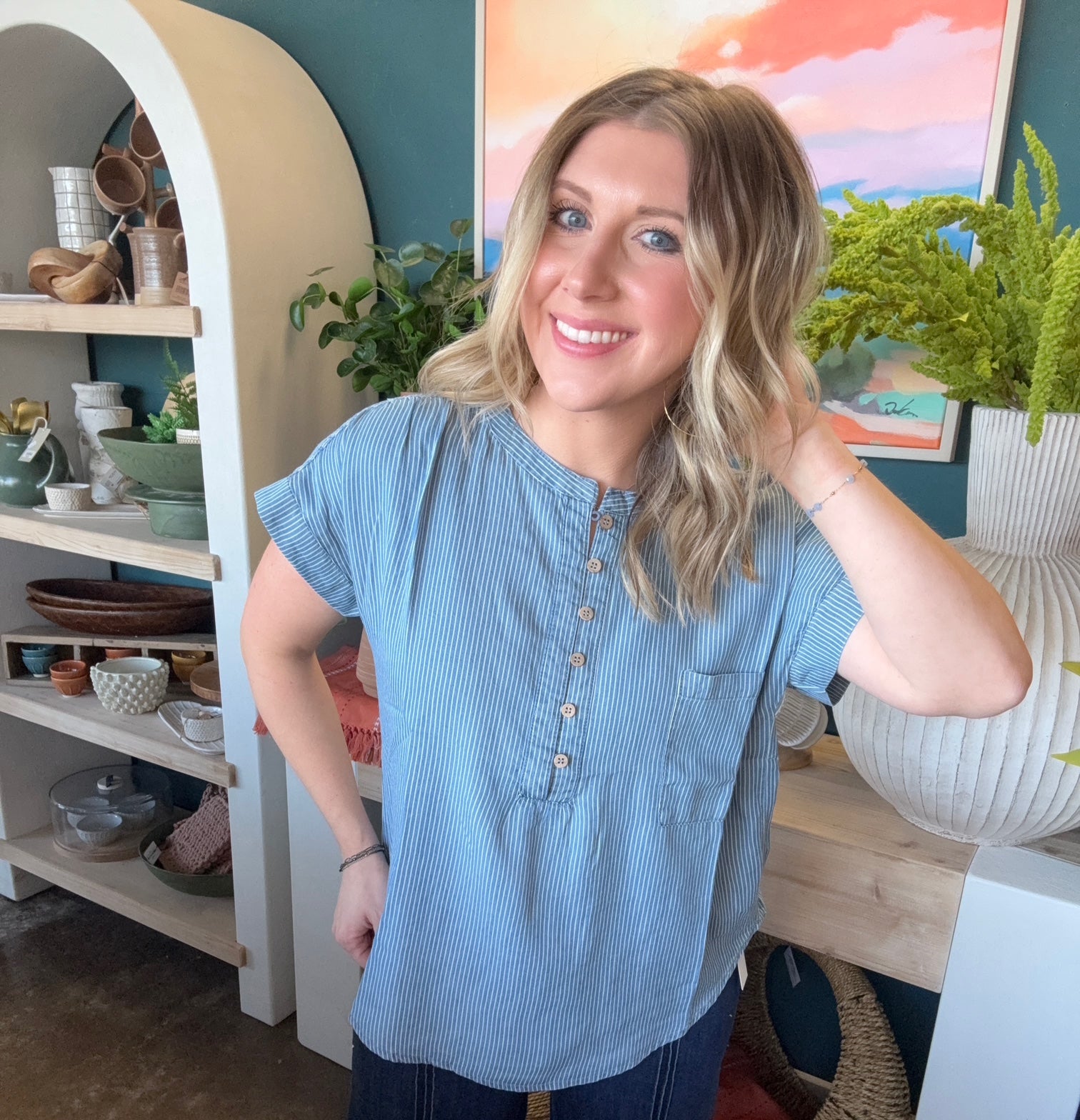 woman wearing blue and white pinstripe boutique blouse with button front