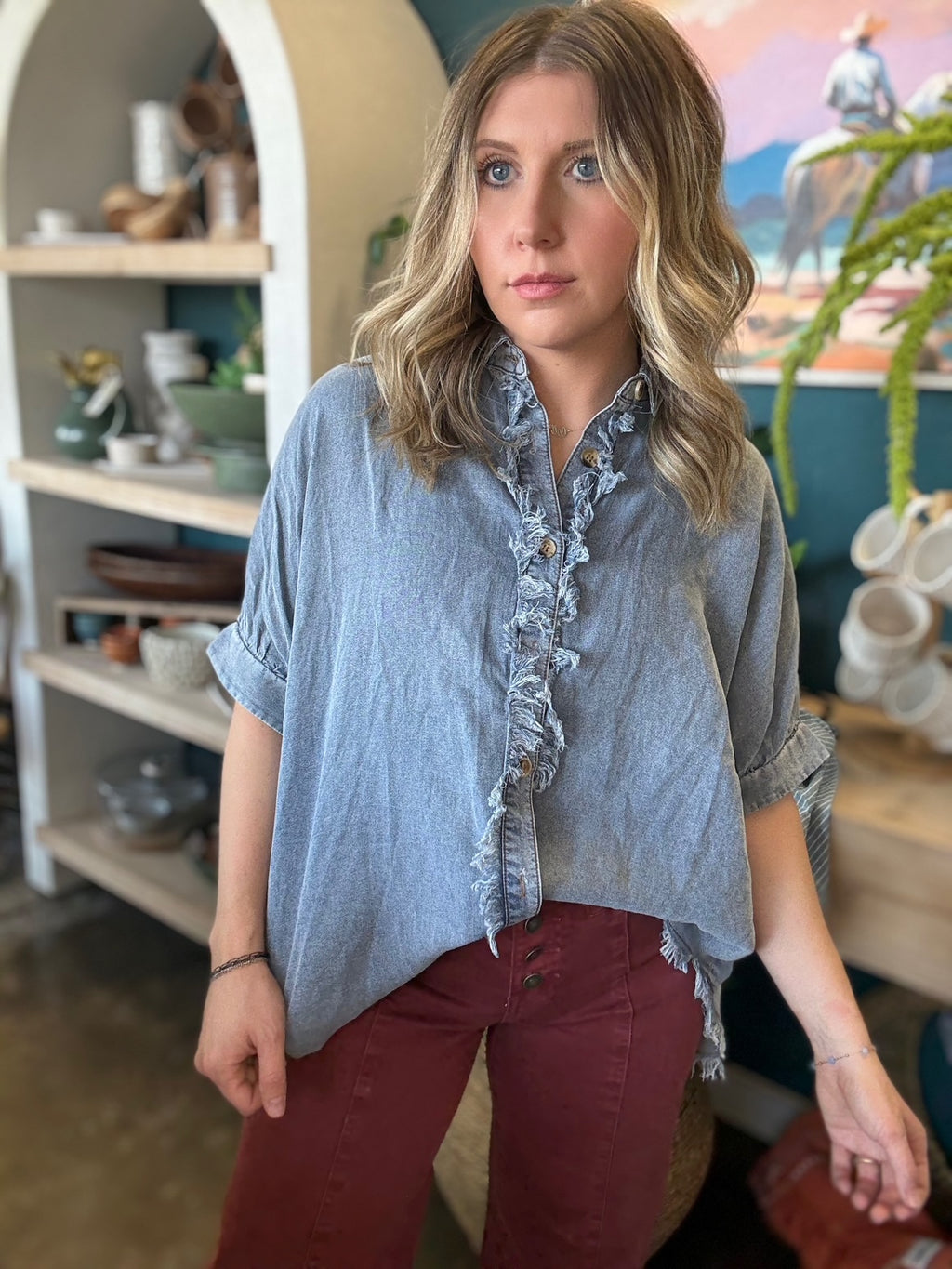 woman wearing frayed chambray boutique button-up top