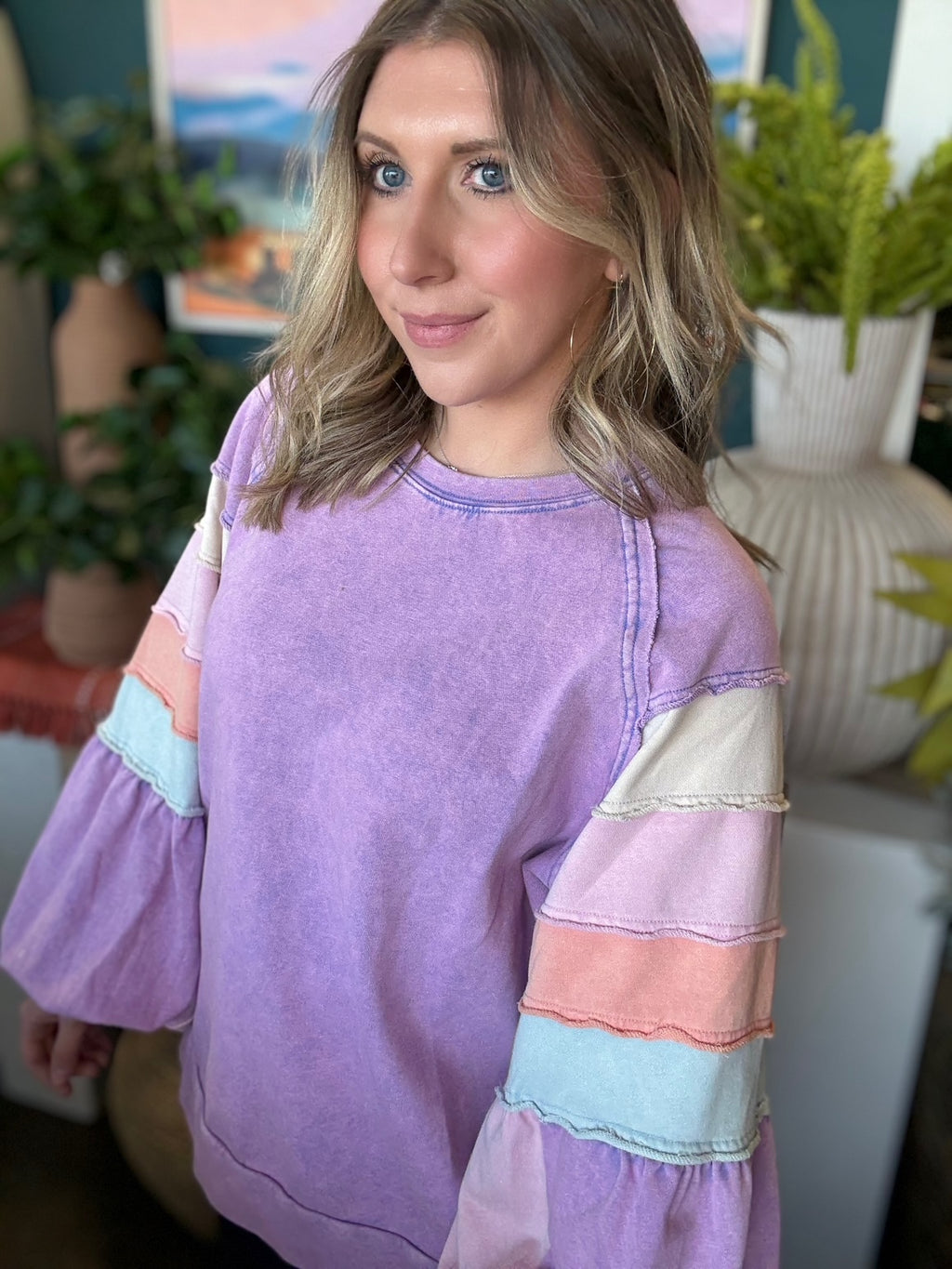 woman wearing lavender boutique pullover with pastel tiered sleeves