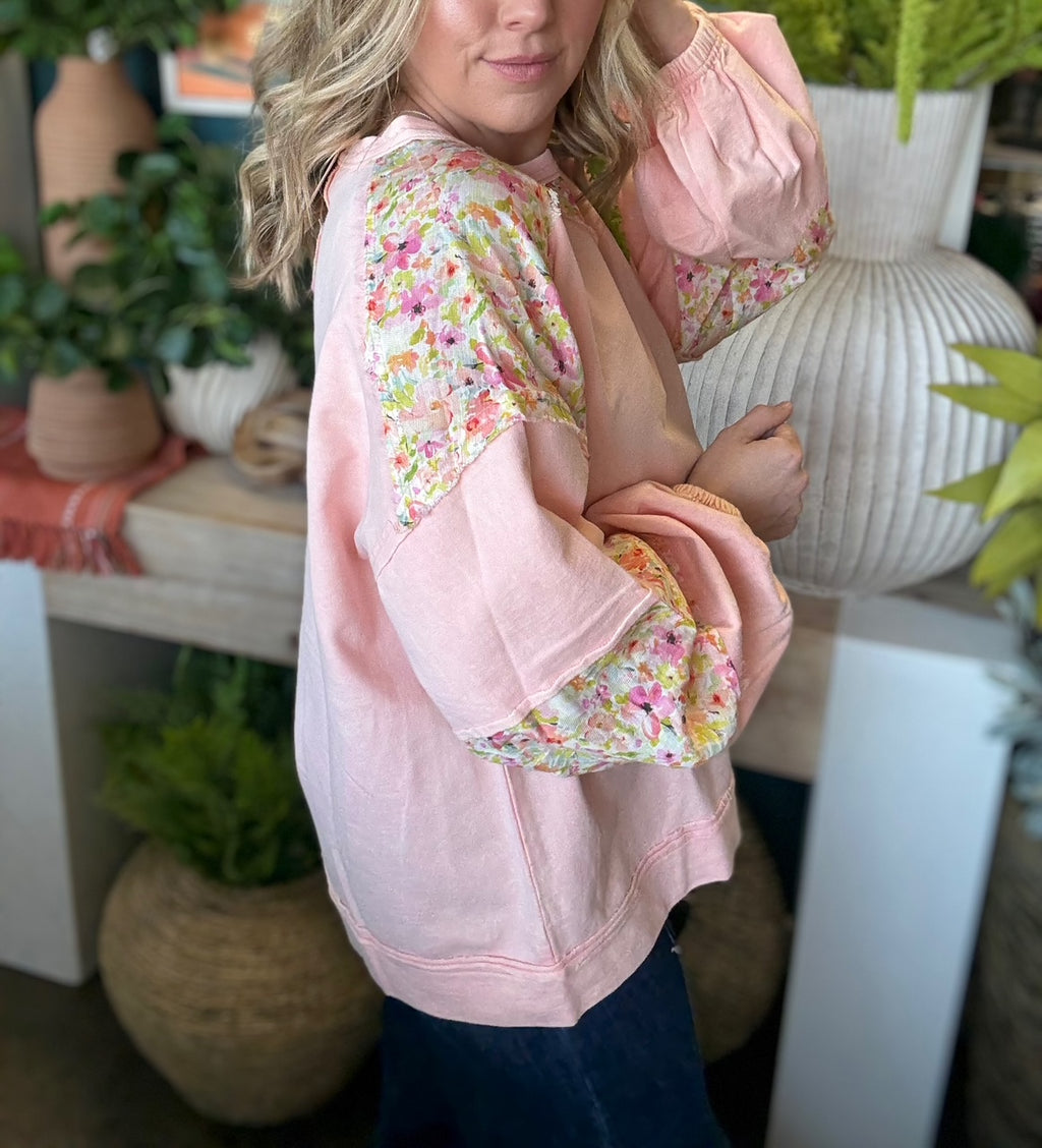 woman wearing blush boutique pullover with floral contrast sleeves