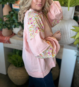 woman wearing blush boutique pullover with floral contrast sleeves