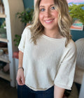 woman wearing cream textured puff sleeve boutique top