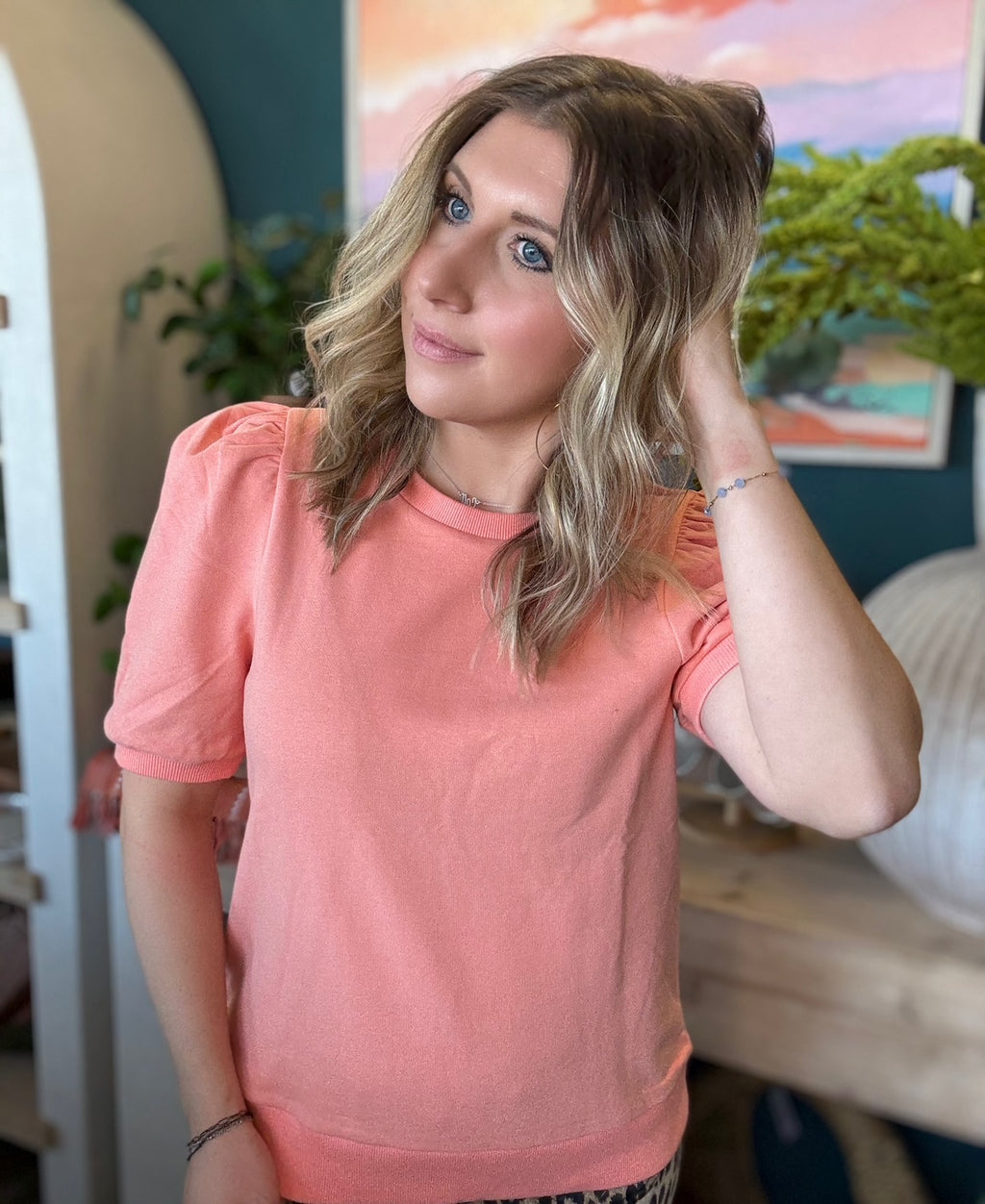 woman wearing coral puff sleeve boutique knit top