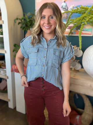 woman wearing blue and white striped boutique button-down top with front pocket
