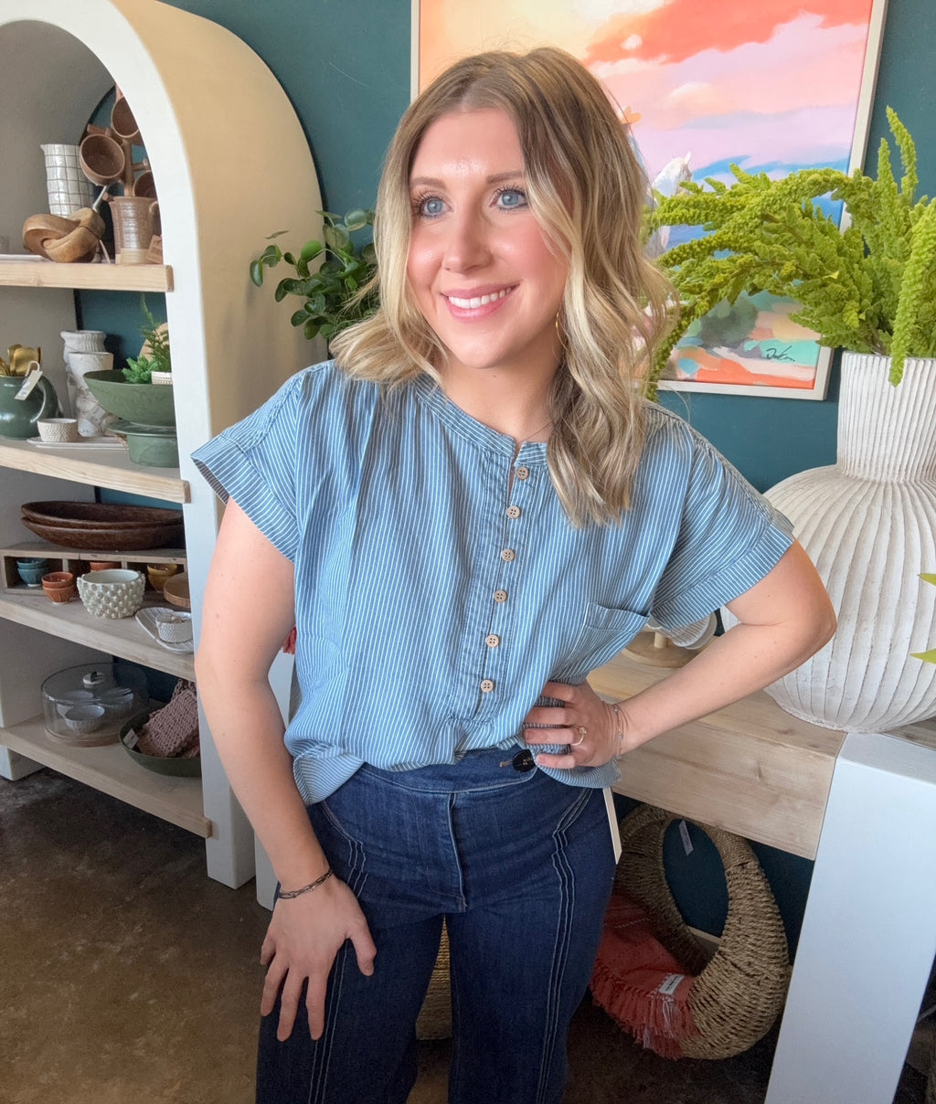 woman wearing blue and white pinstripe boutique blouse with button front