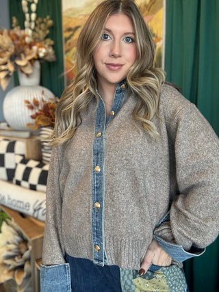 Woman wearing a latte knit sweater with a washed-denim collar, button placket, statement cuffs, and gold-tone buttons.