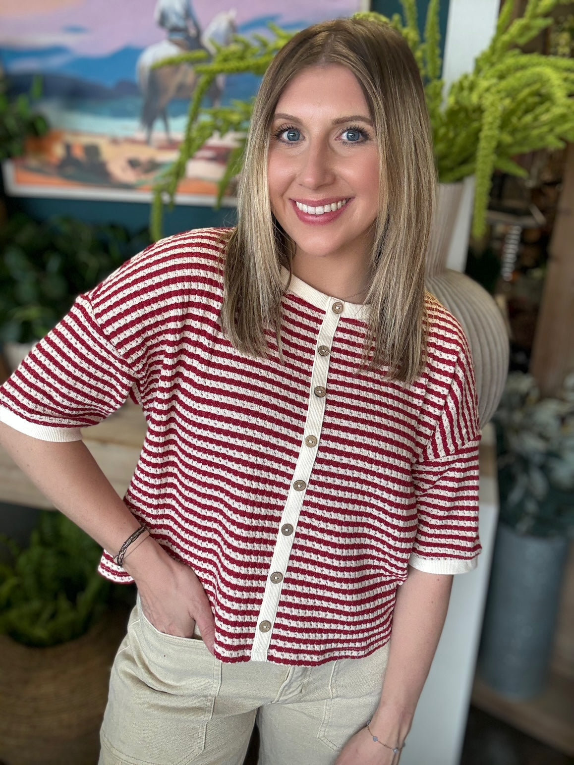 Red and cream striped button front boutique top styled with neutral pants at Pill Box Boutique