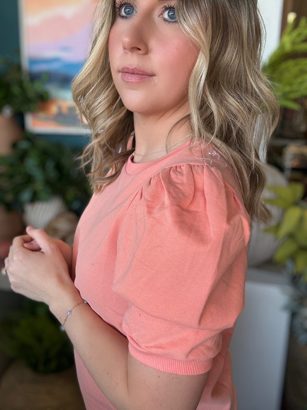 woman wearing coral puff sleeve boutique knit top