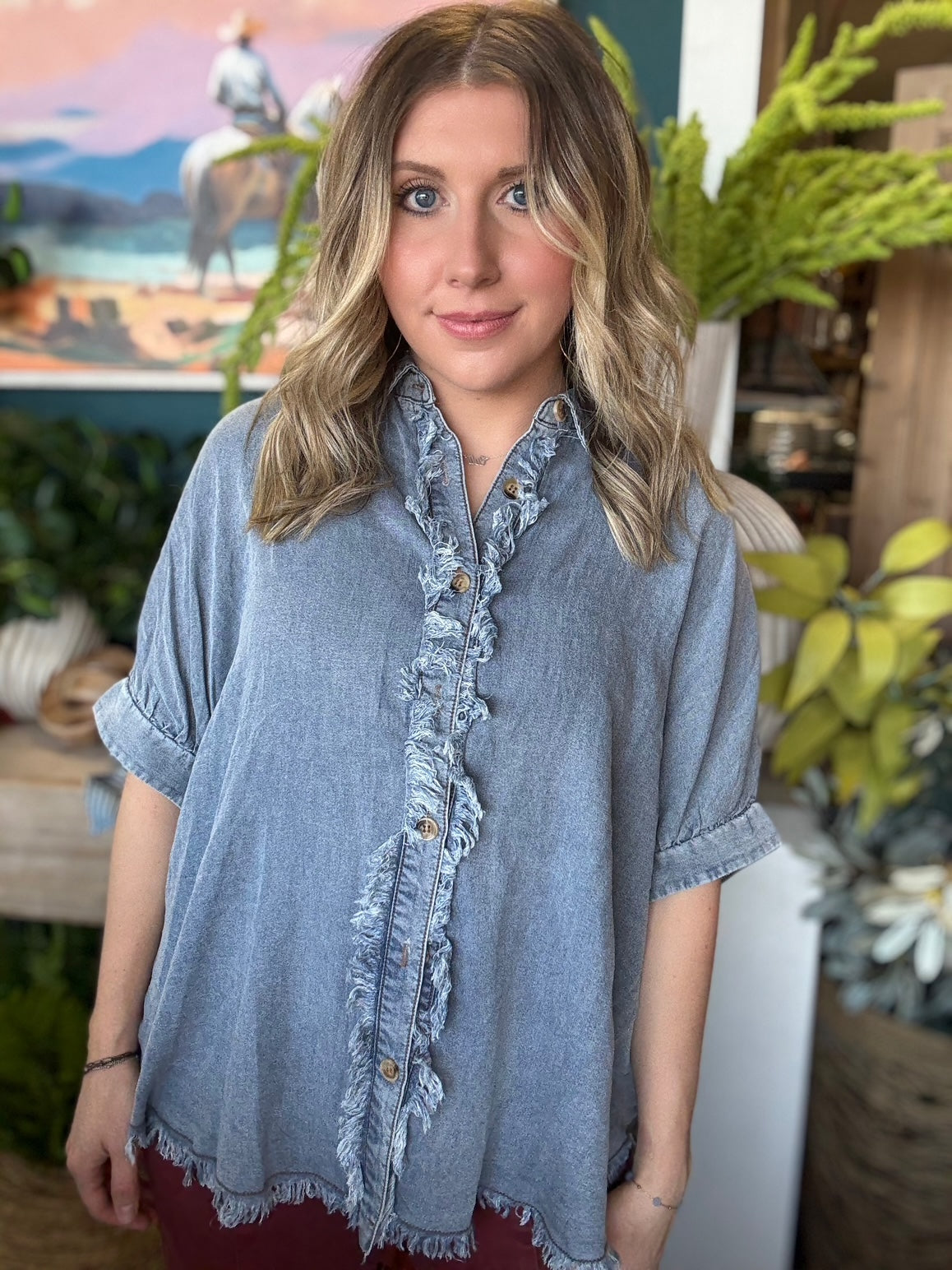 woman wearing frayed chambray boutique button-up top
