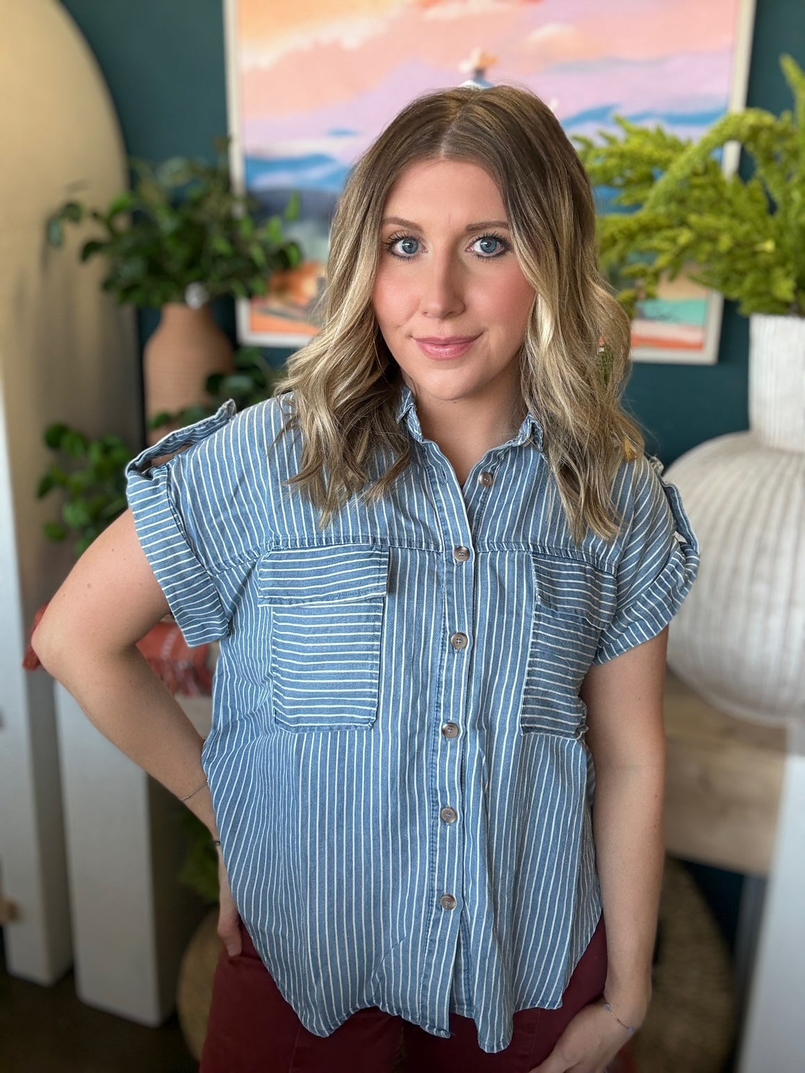 woman wearing blue and white striped boutique button-down top with front pocket