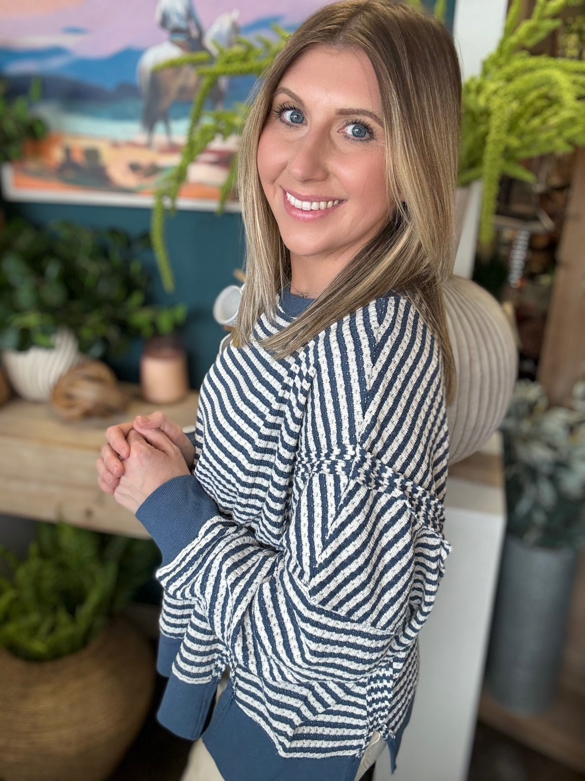 Navy and cream striped relaxed fit boutique top styled with neutral pants at Pill Box Boutique