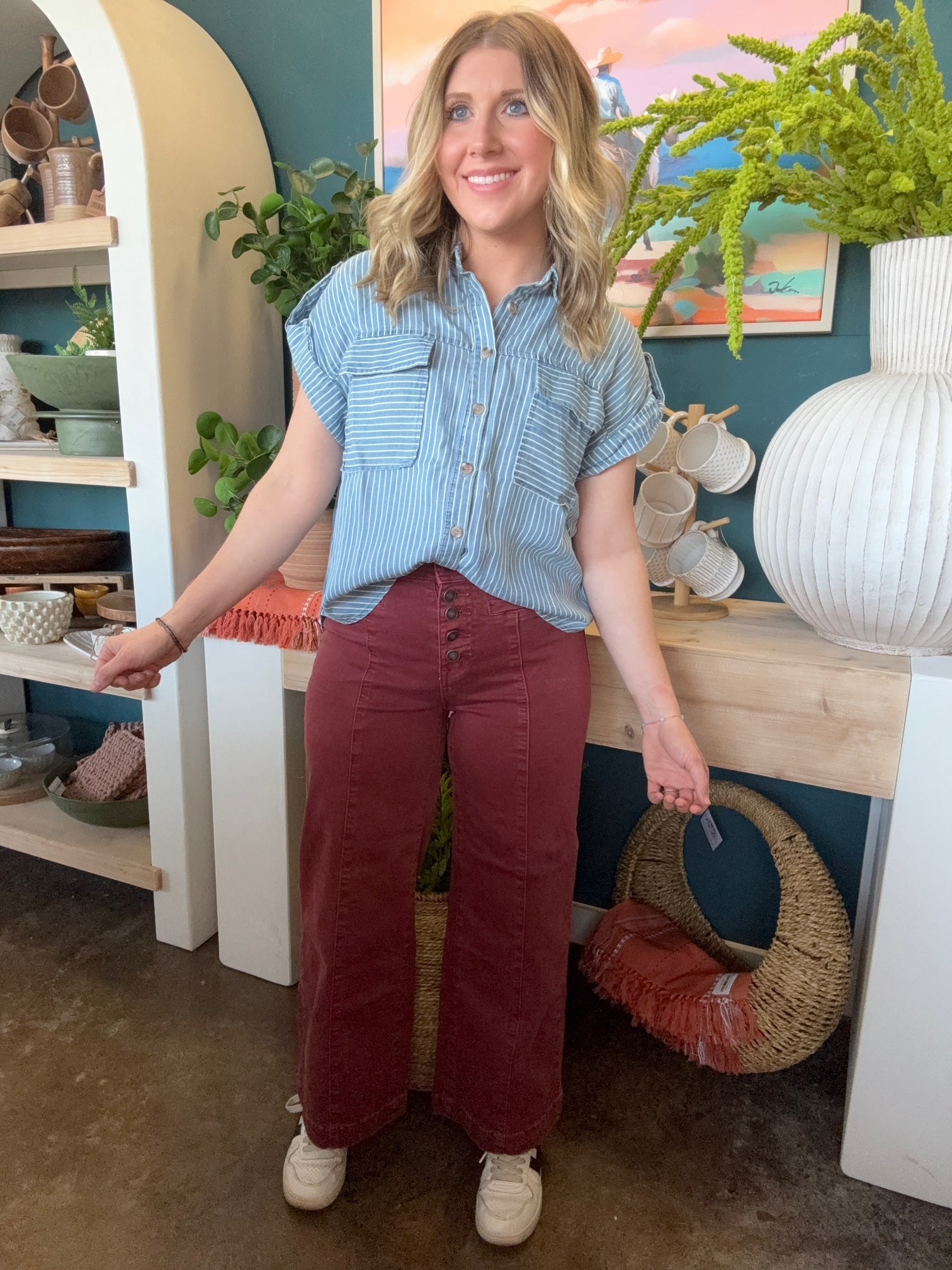 woman wearing blue and white striped boutique button-down top with front pocket