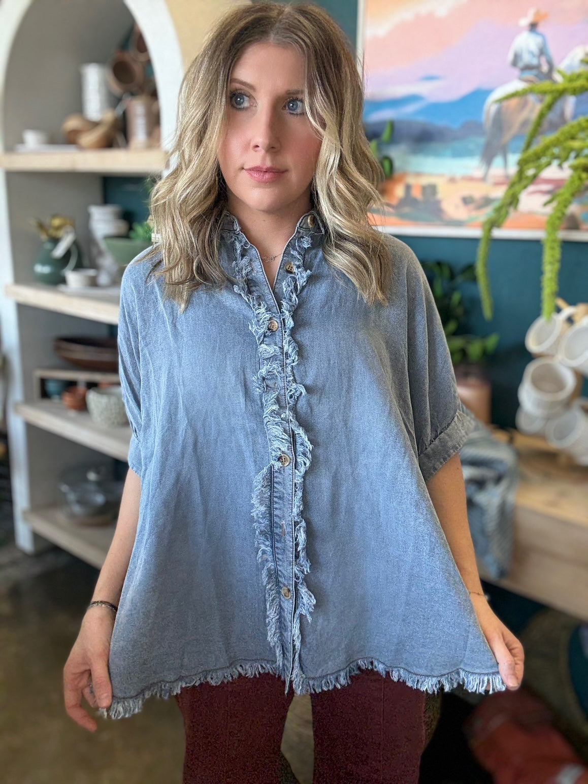 woman wearing frayed chambray boutique button-up top
