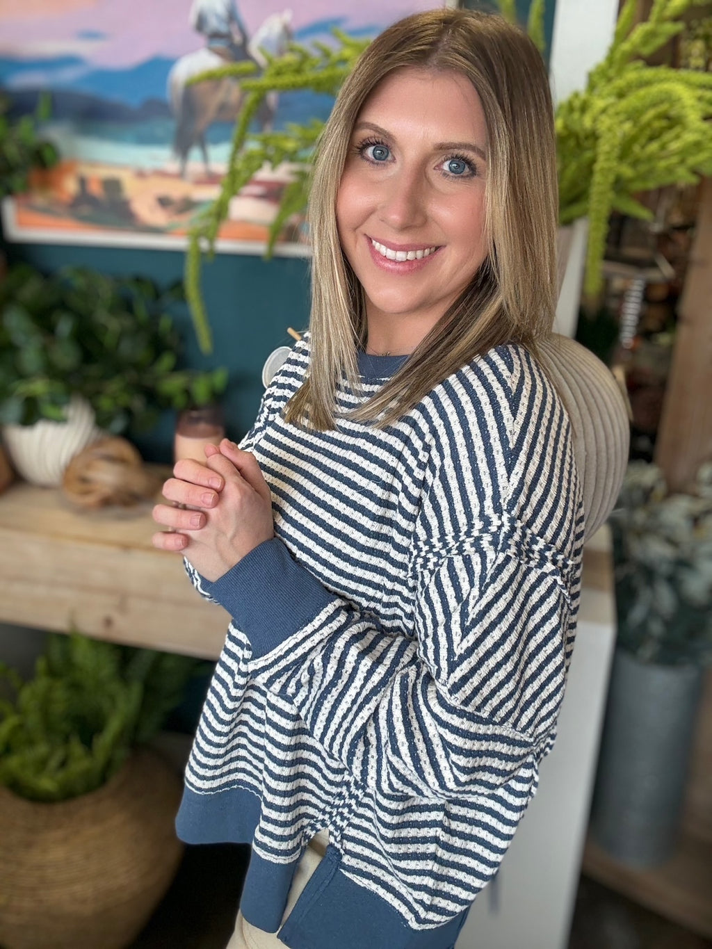 Navy and cream striped relaxed fit boutique top styled with neutral pants at Pill Box Boutique