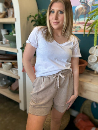 woman wearing neutral drawstring boutique lounge shorts with pockets