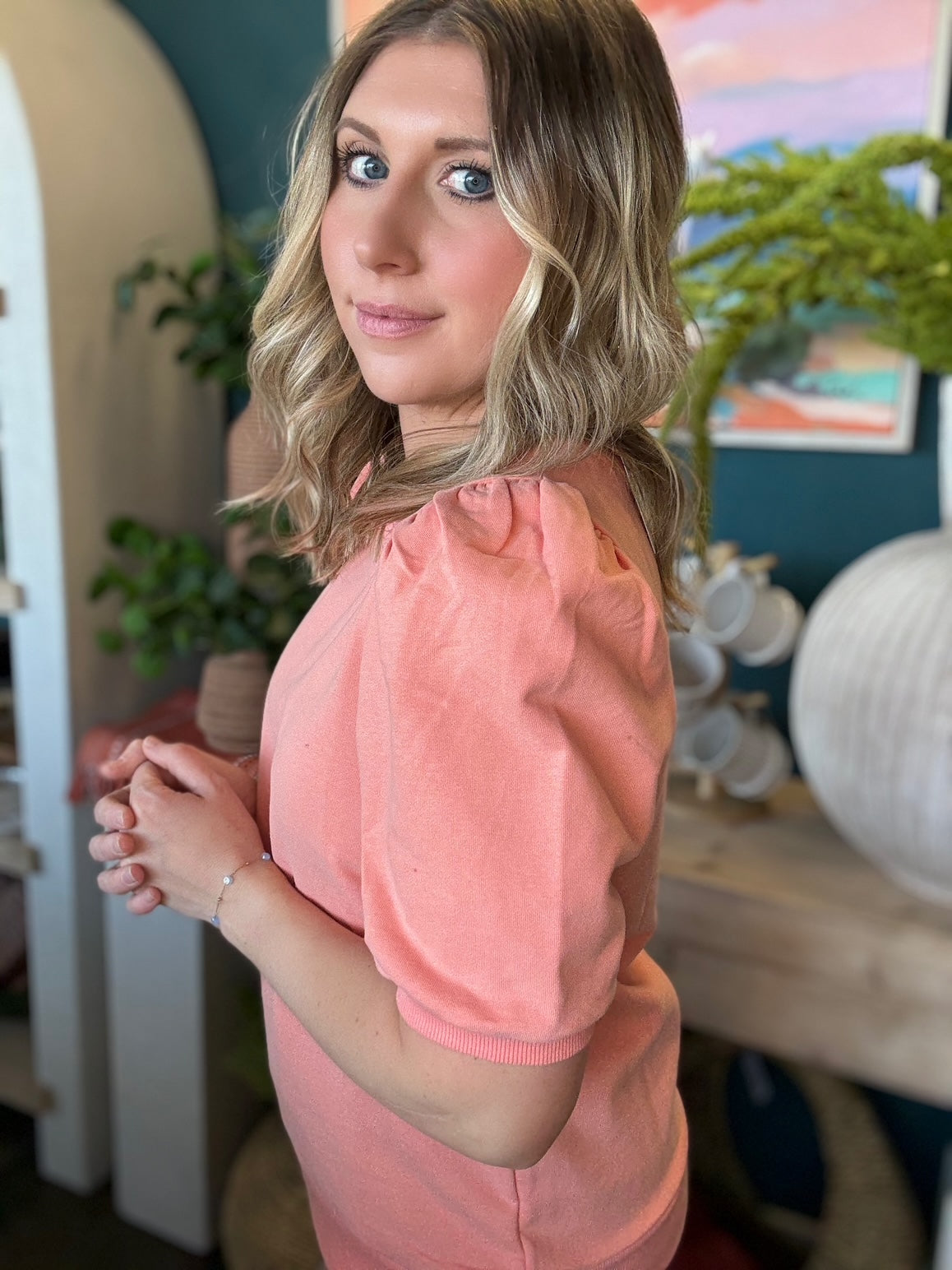 woman wearing coral puff sleeve boutique knit top
