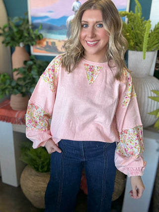 woman wearing blush boutique pullover with floral contrast sleeves