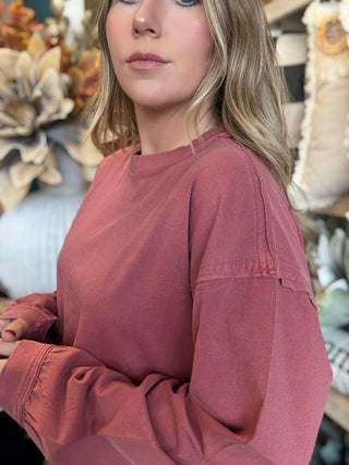 Woman wearing a winter-berry mineral-wash long-sleeve tee with dropped shoulders and balloon sleeves