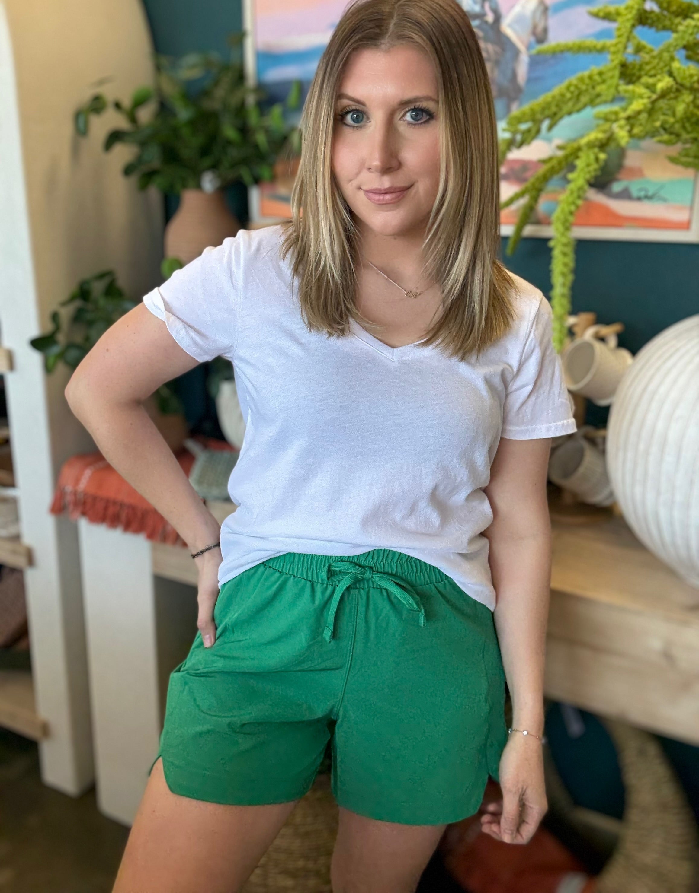 woman wearing emerald green eyelet boutique drawstring shorts