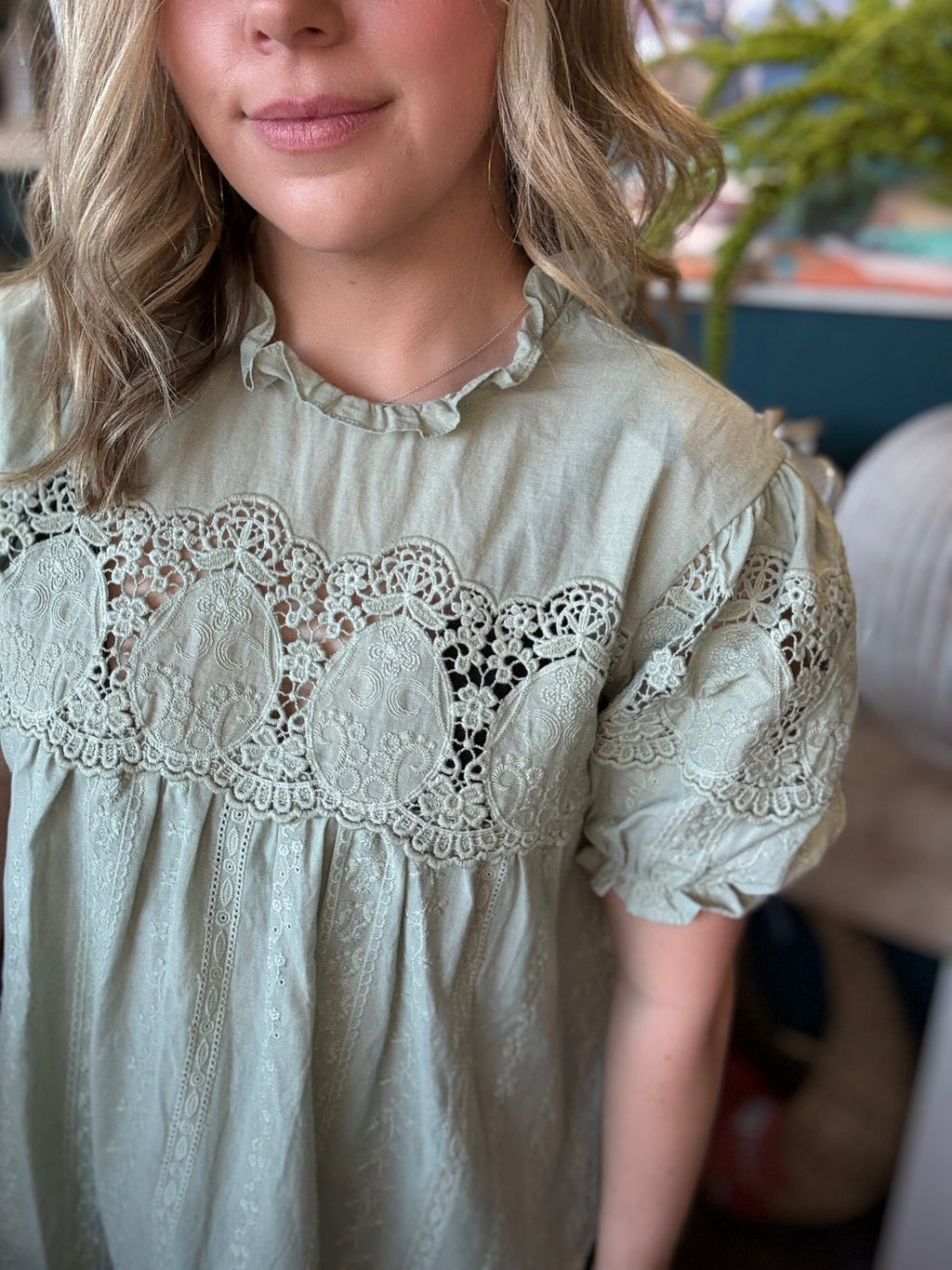 woman wearing sage green lace puff sleeve boutique blouse with embroidered fabric

Tags