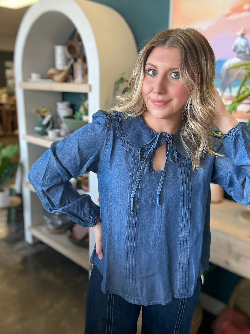 woman wearing chambray boutique blouse with tie neckline and pintuck detailing