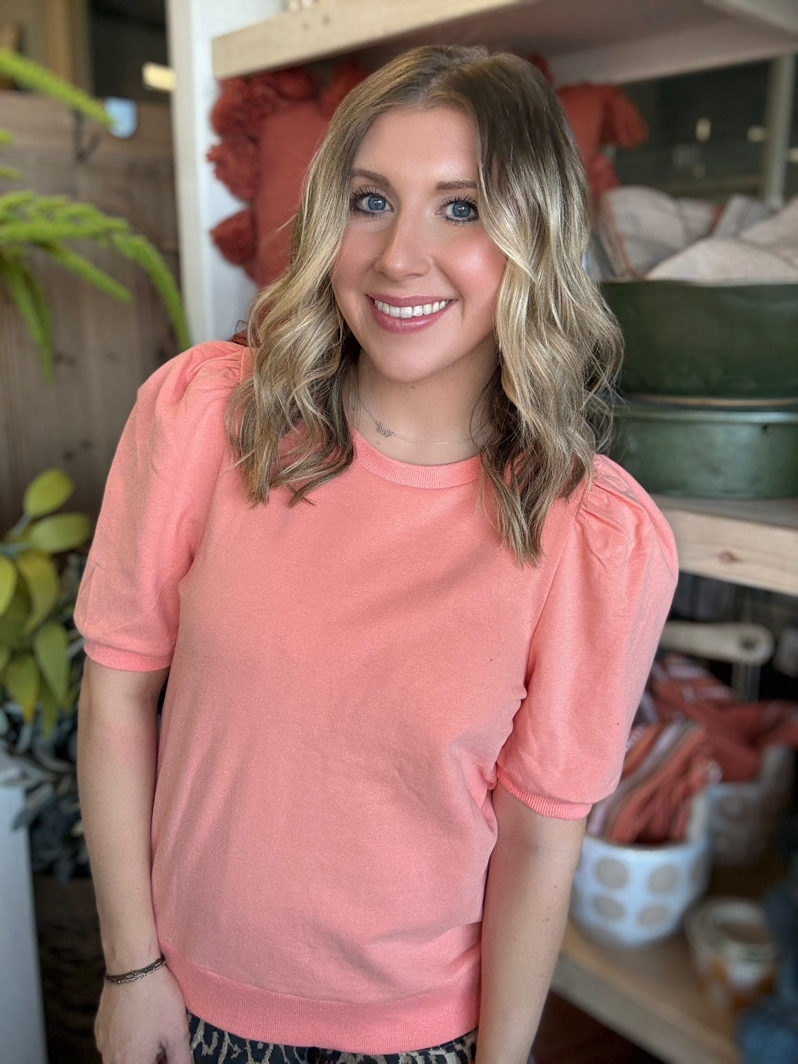 woman wearing coral puff sleeve boutique knit top