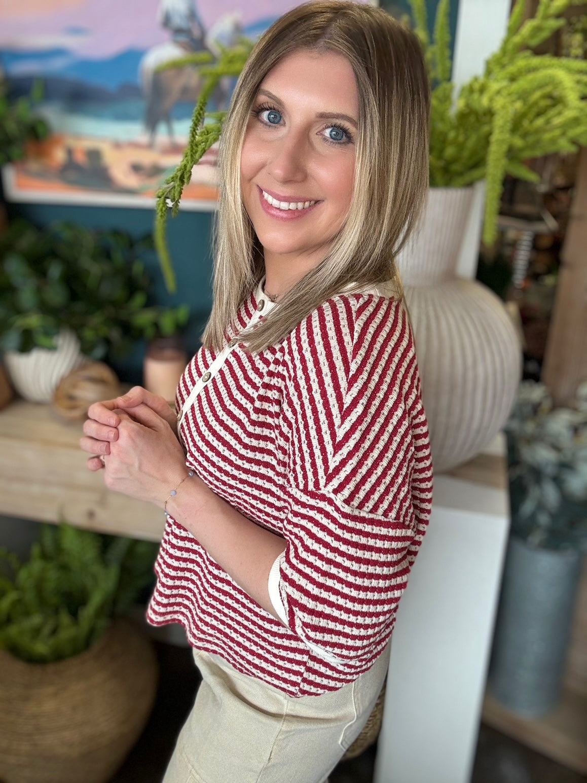 Red and cream striped button front boutique top styled with neutral pants at Pill Box Boutique