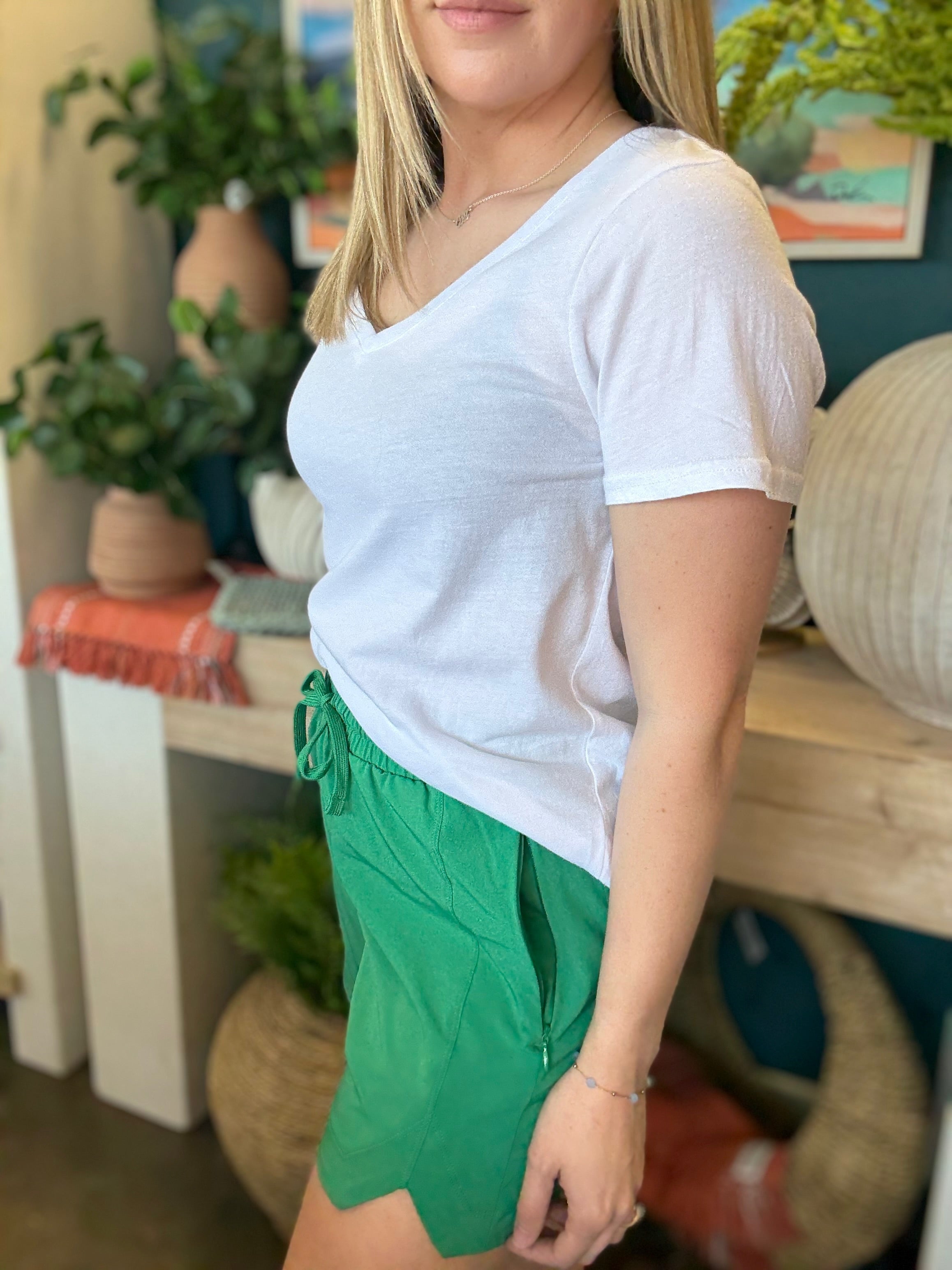 woman wearing emerald green eyelet boutique drawstring shorts