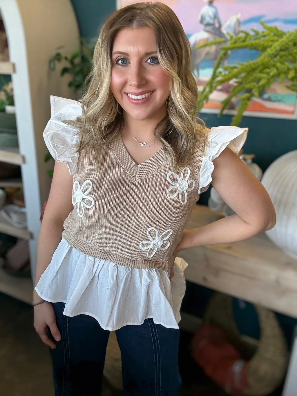 woman wearing floral ruffle knit boutique top with layered white peplum hem