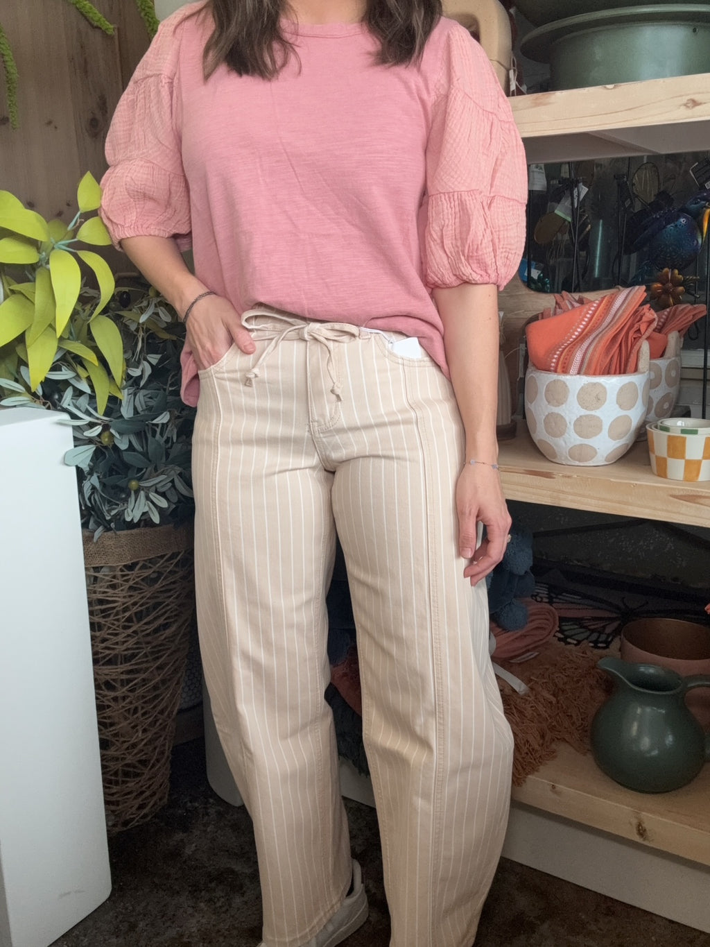 woman wearing sand striped drawstring boutique straight leg pants