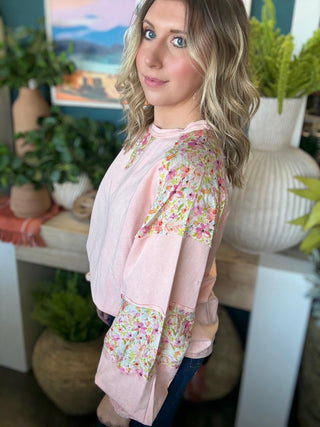 woman wearing blush boutique pullover with floral contrast sleeves