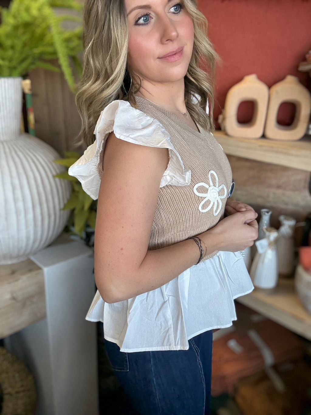 woman wearing floral ruffle knit boutique top with layered white peplum hem