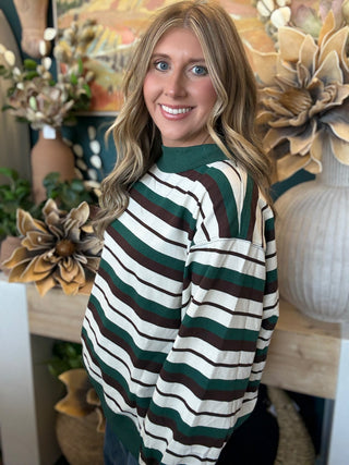Woman wearing a teal French terry striped sweatshirt from Pill Box Boutique