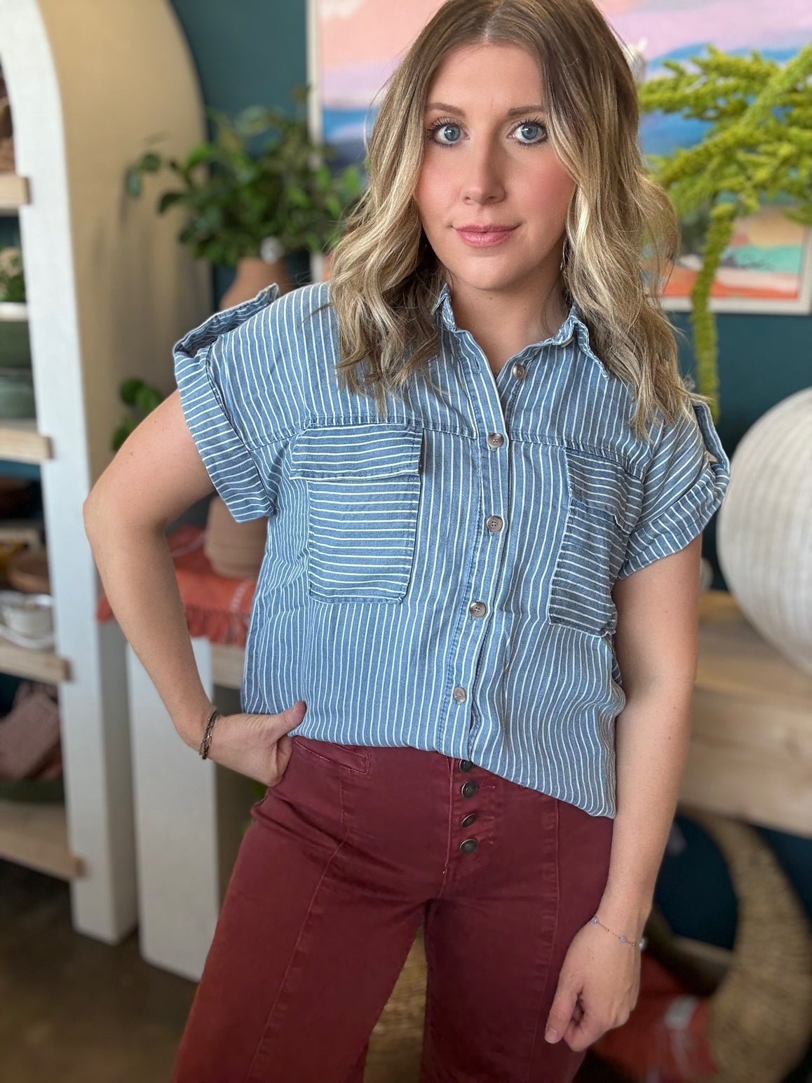 woman wearing blue and white striped boutique button-down top with front pocket