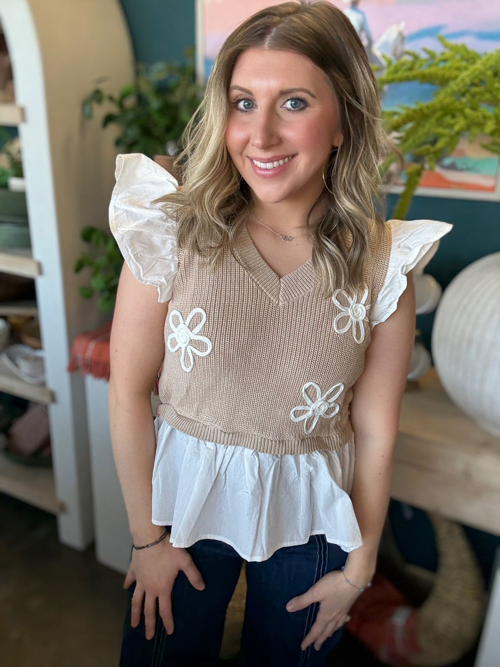 woman wearing floral ruffle knit boutique top with layered white peplum hem