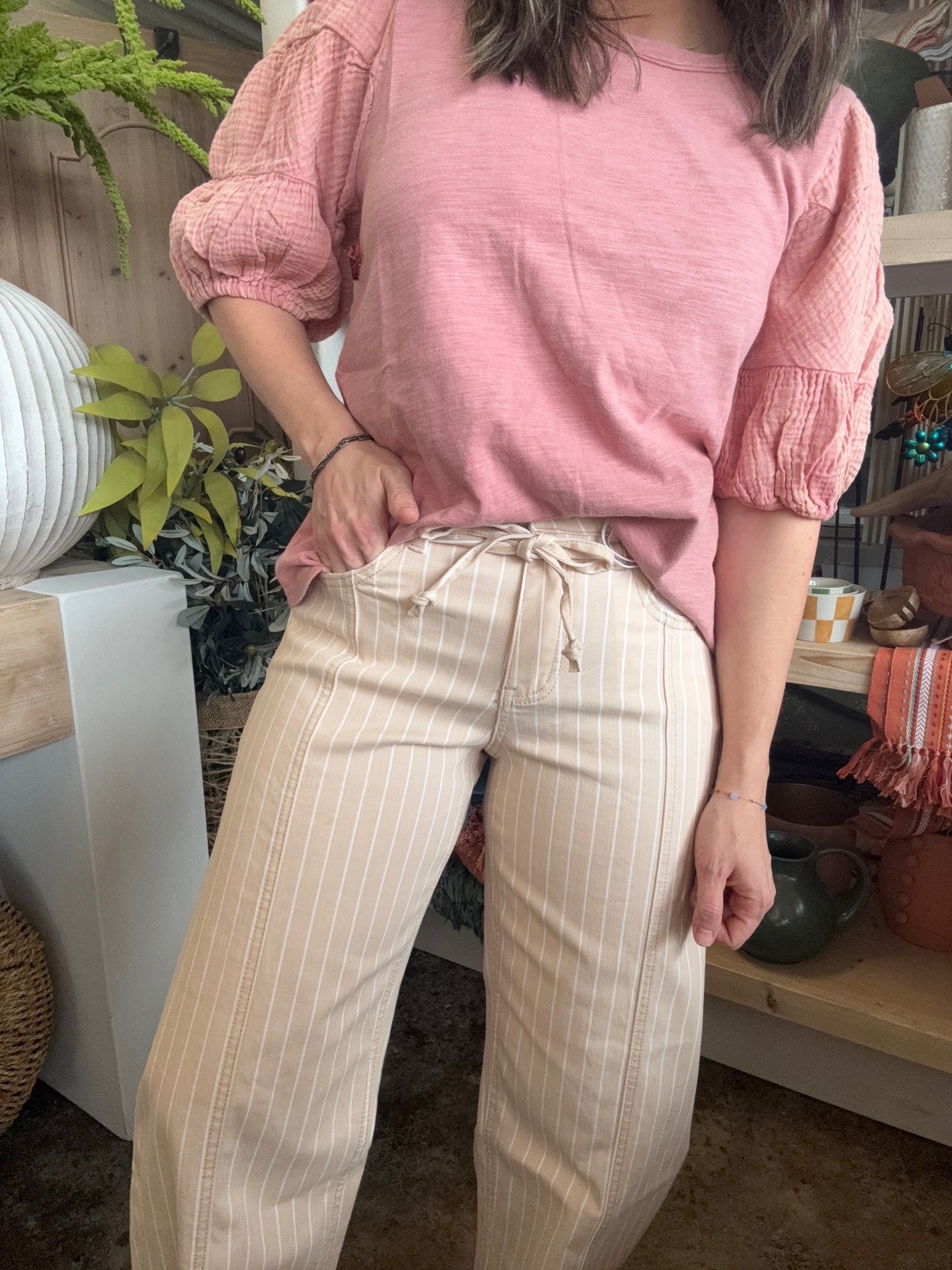 woman wearing dusty rose puff sleeve boutique top