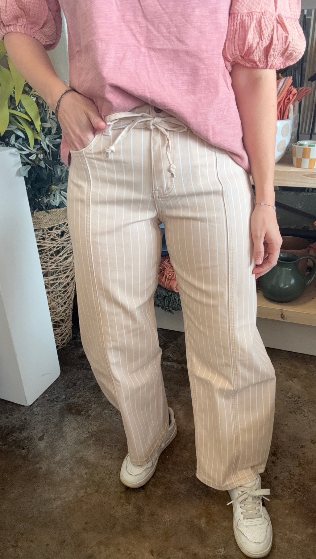 woman wearing sand striped drawstring boutique straight leg pants