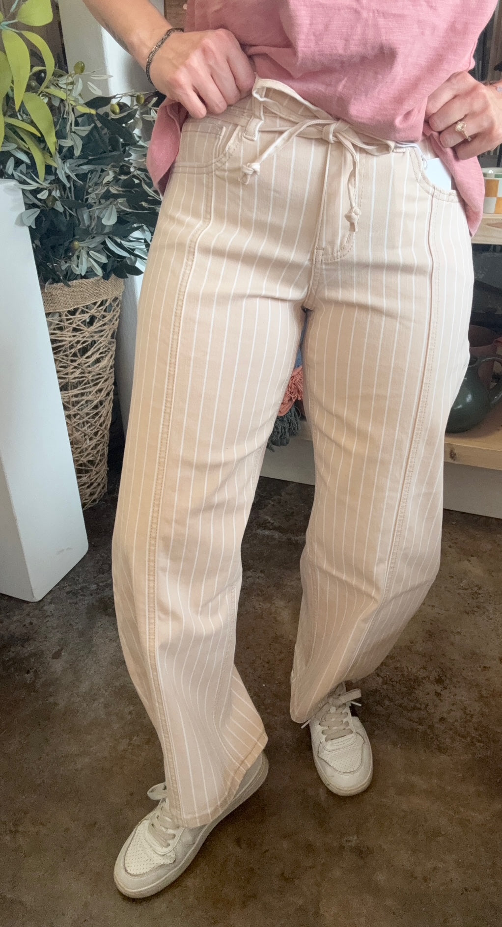 woman wearing sand striped drawstring boutique straight leg pants