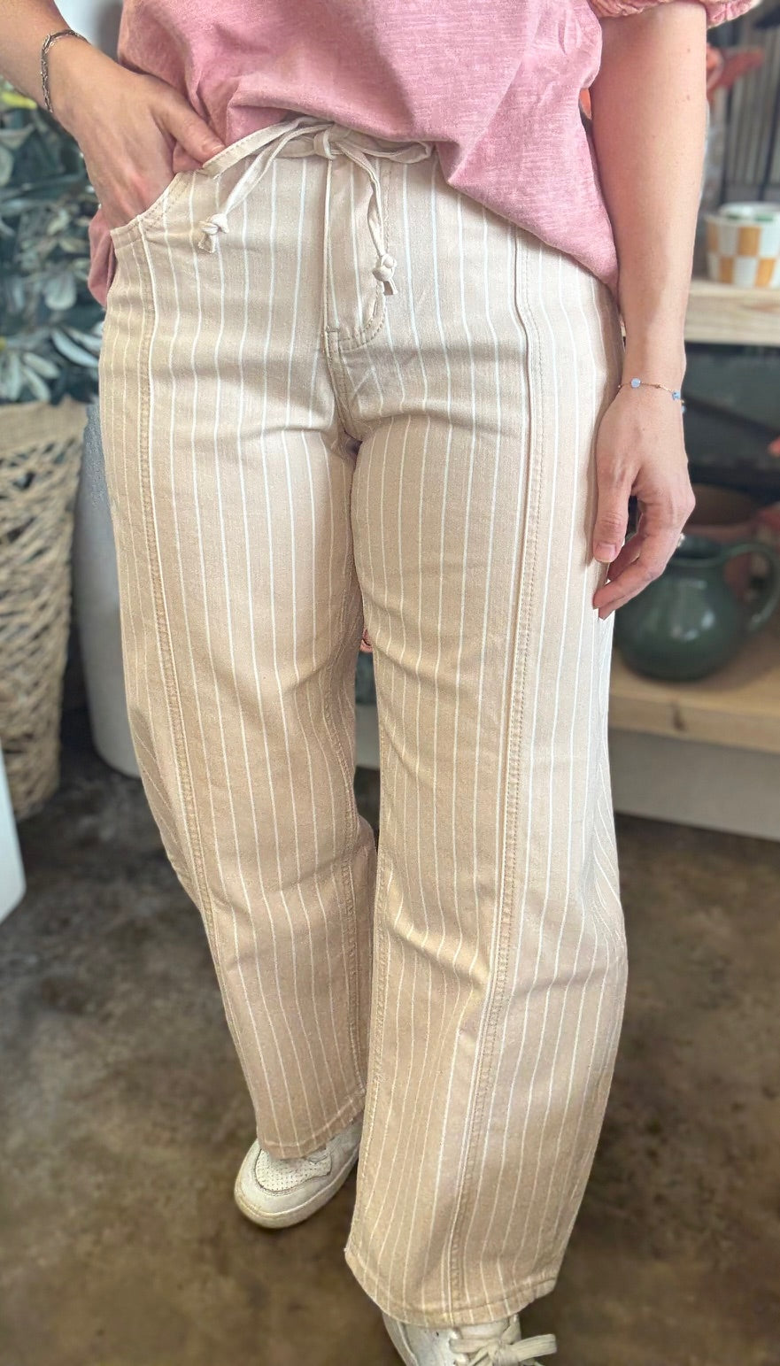 woman wearing sand striped drawstring boutique straight leg pants