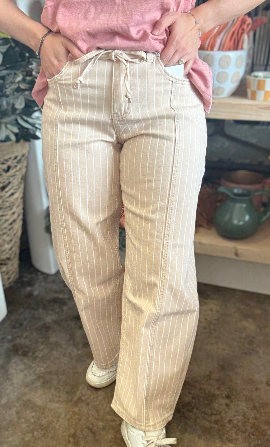 woman wearing sand striped drawstring boutique straight leg pants