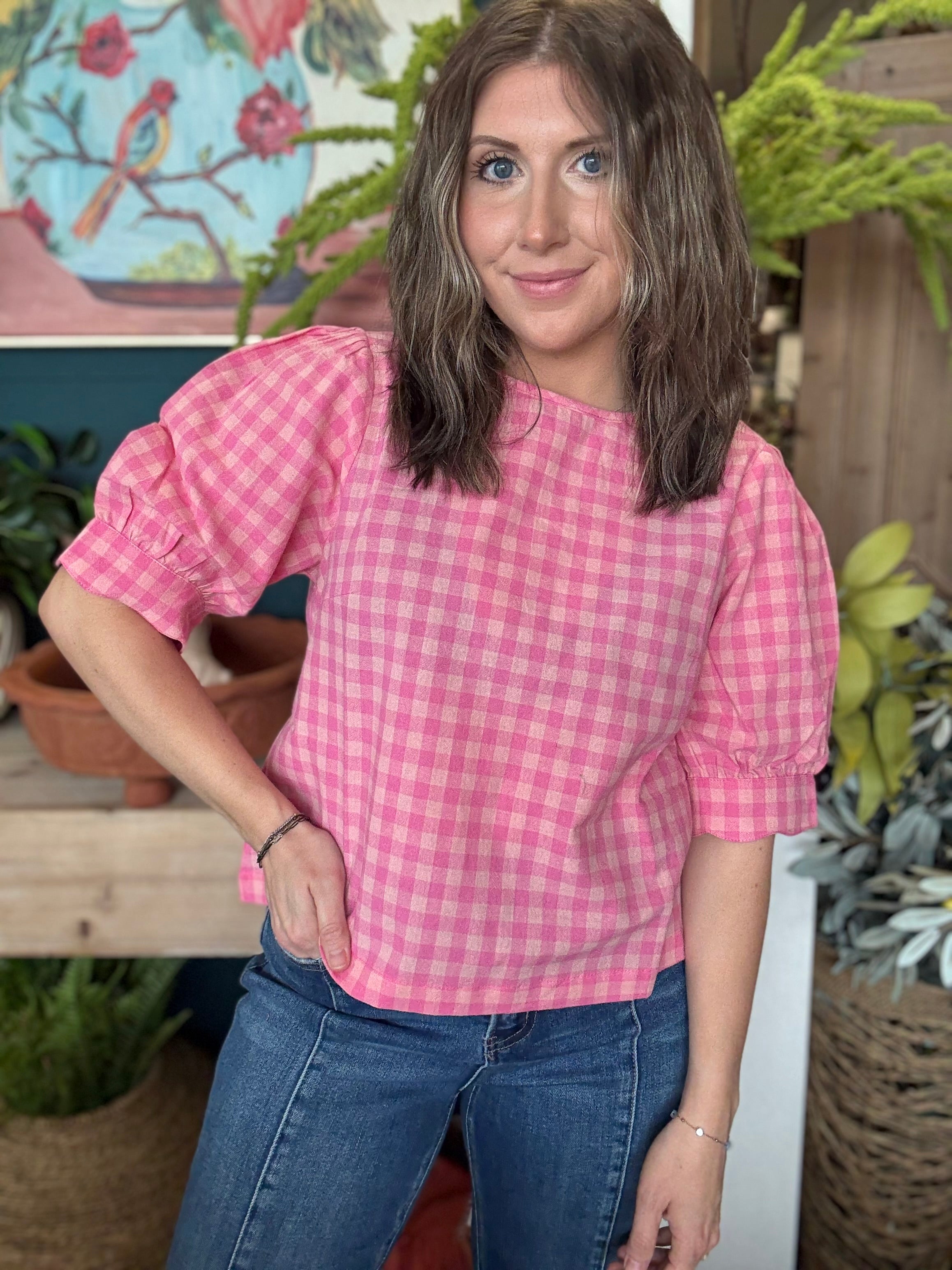 woman wearing pink gingham puff sleeve boutique top