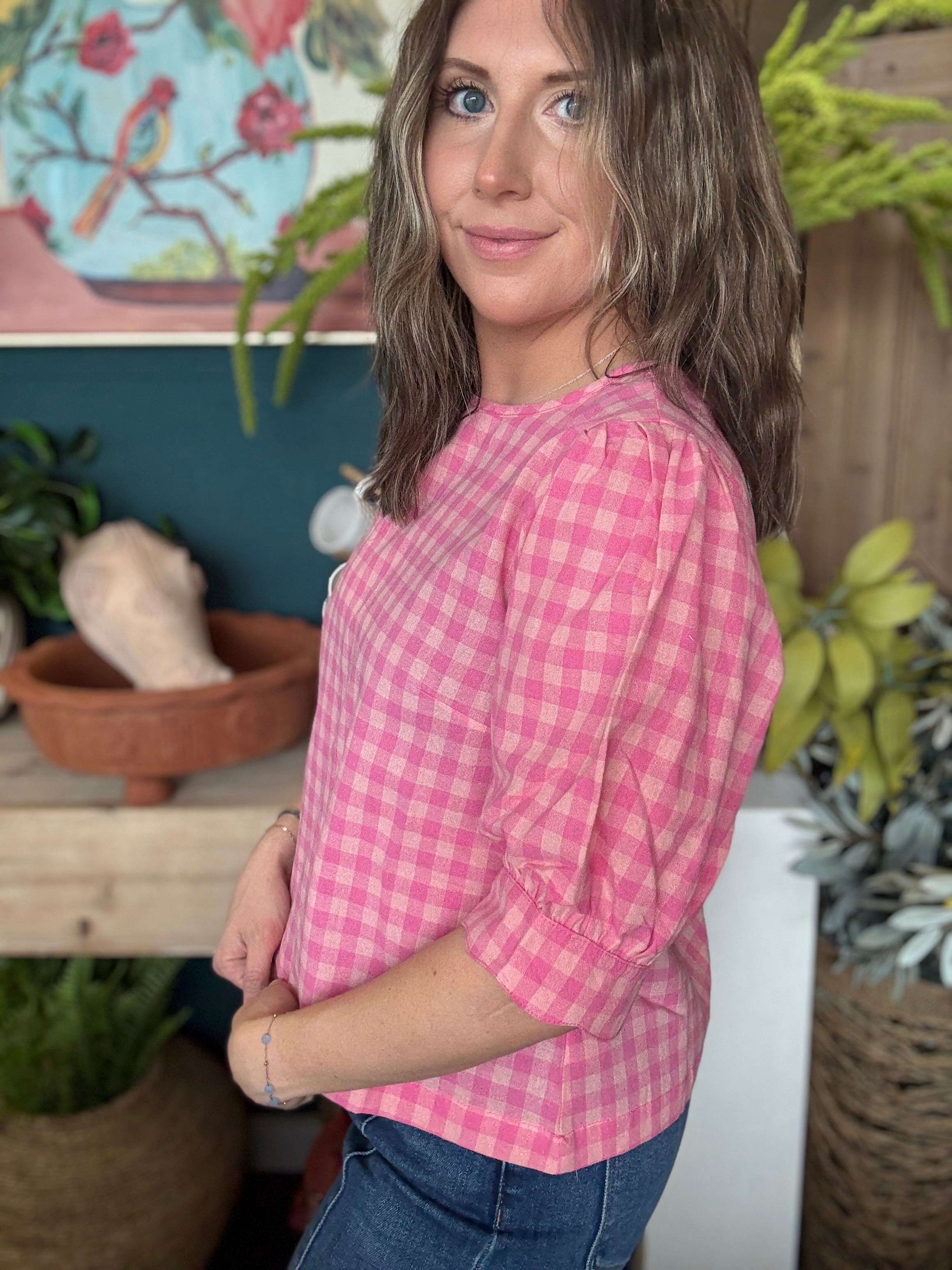 woman wearing pink gingham puff sleeve boutique top