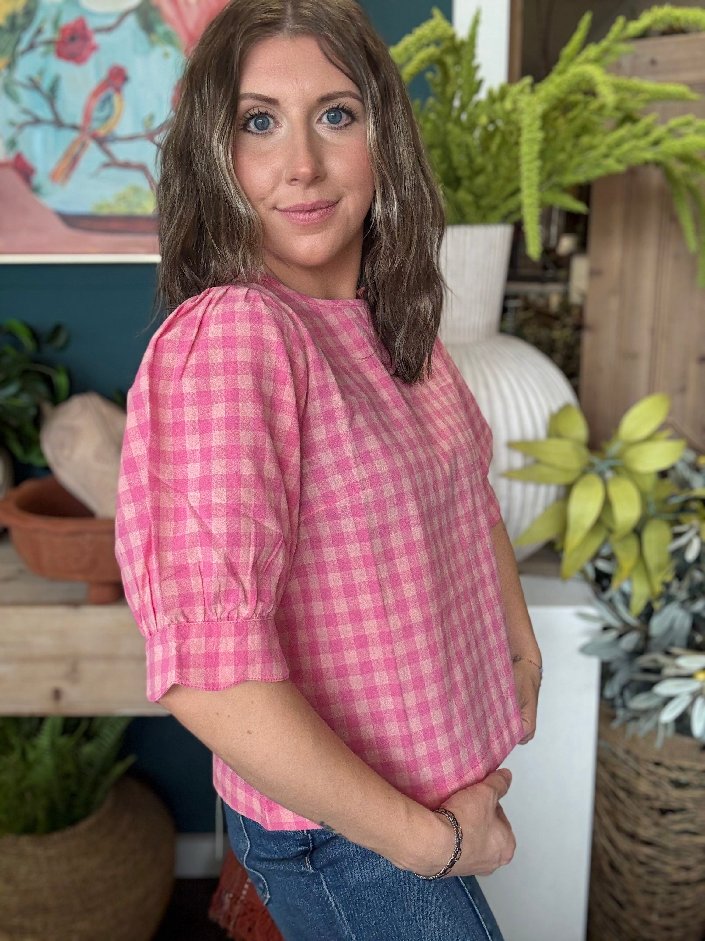 woman wearing pink gingham puff sleeve boutique top
